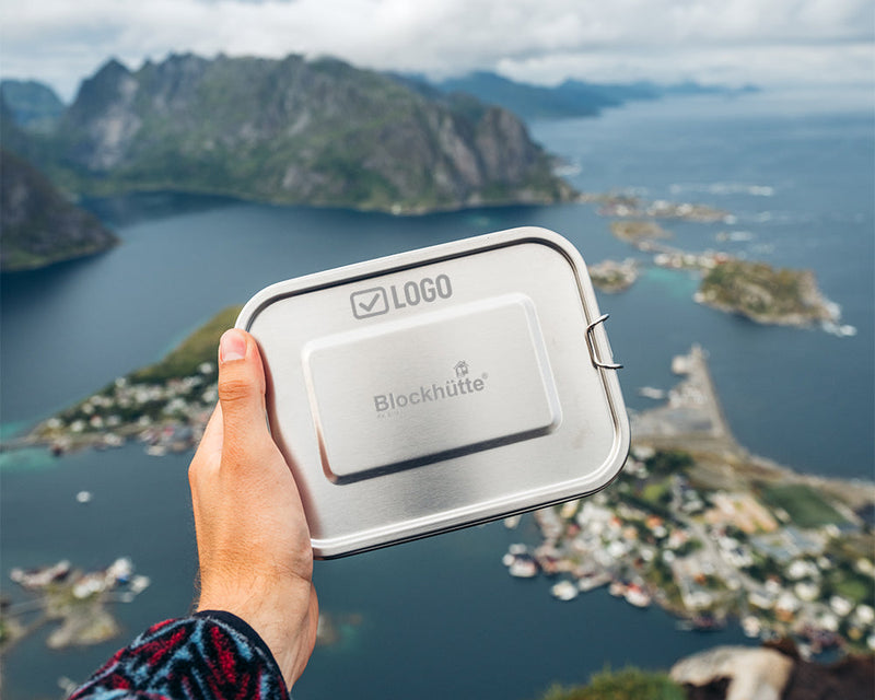 Stainless steel lunch box with an engraved company logo