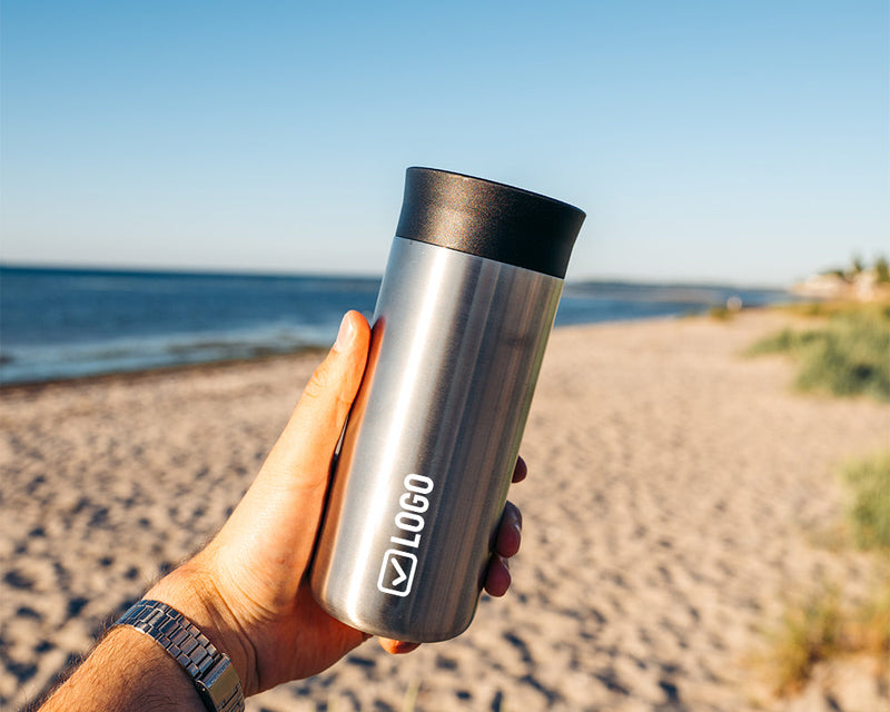 Stainless steel insulated mug with an engraved company logo