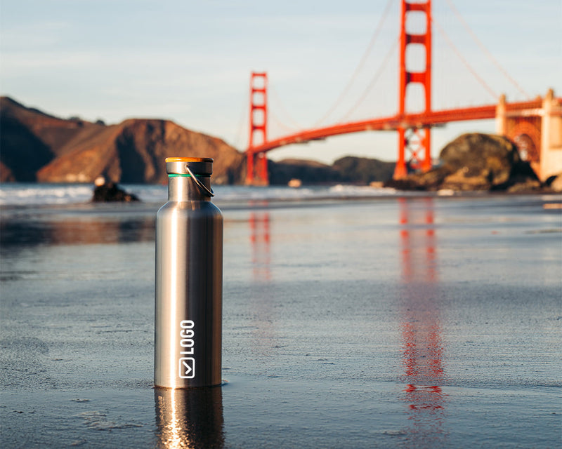 Stainless steel water bottle with a silicone sleeve and an engraved company logo